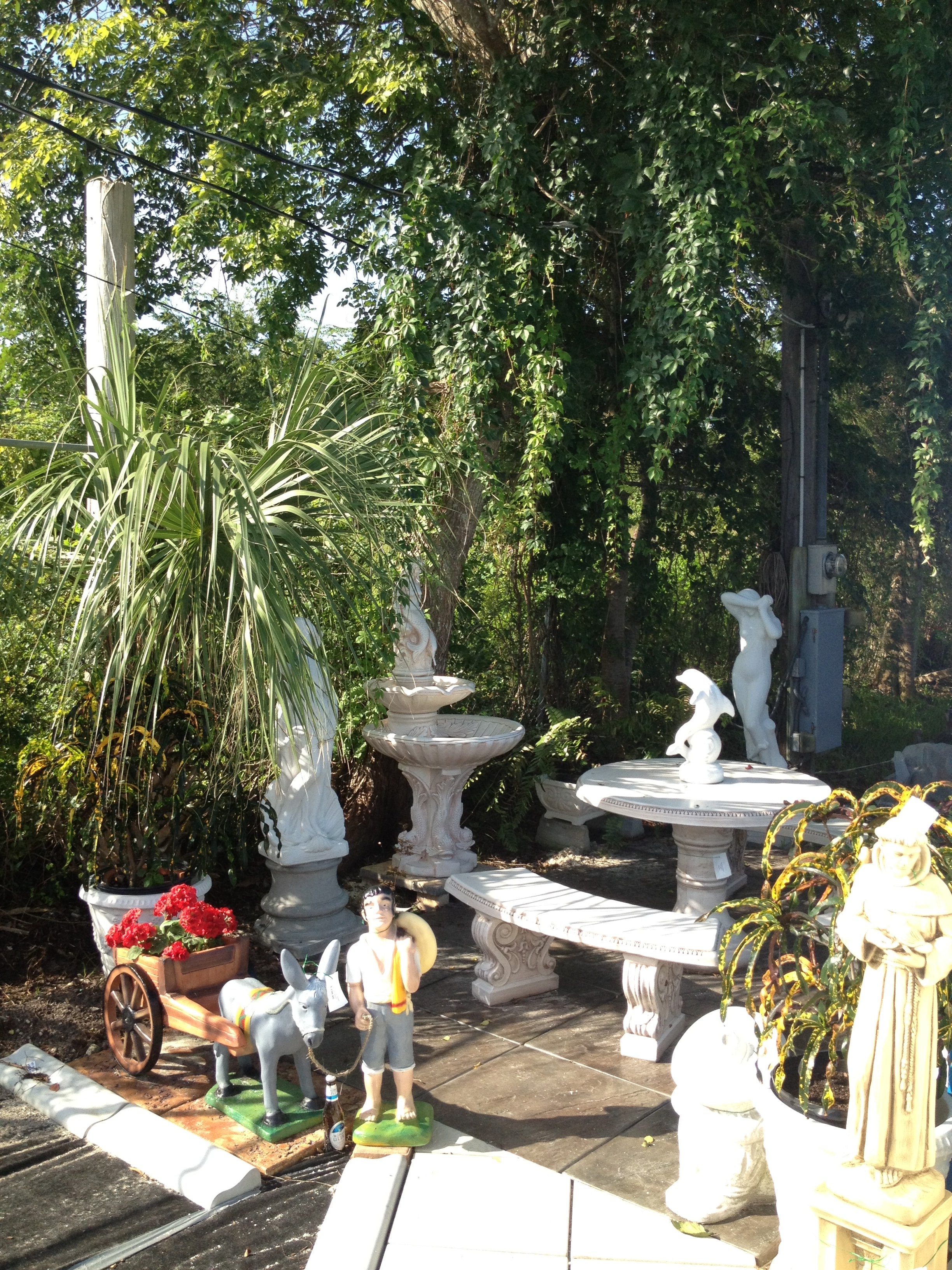 LunaCrete — garden courtyard with ivy covered walls and statues