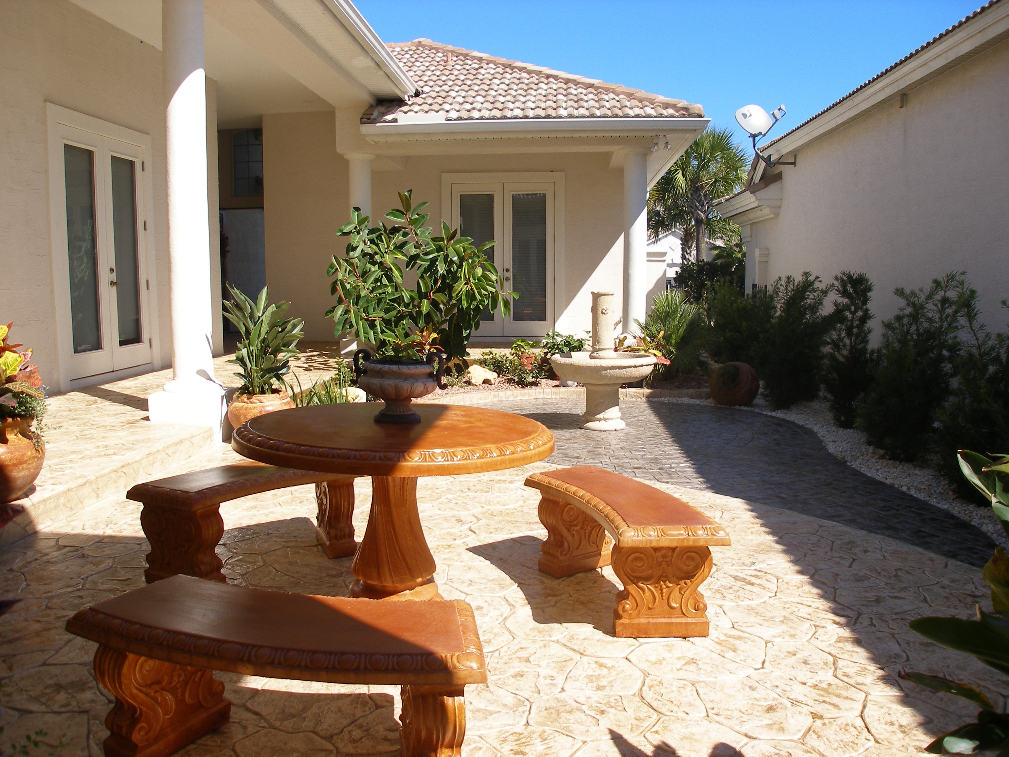 LunaCrete — luxury home courtyard with wooden furniture